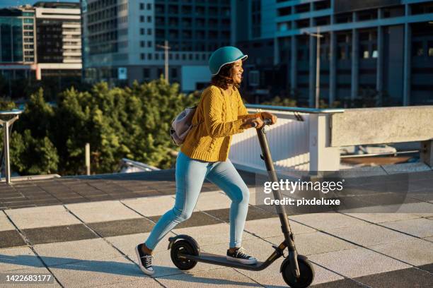 electric scooter travel in the city with a happy woman from mexico riding in a urban town. female mexican traveler with a smile using eco friendly, sustainability and green energy transportation - woman riding scooter stock pictures, royalty-free photos & images