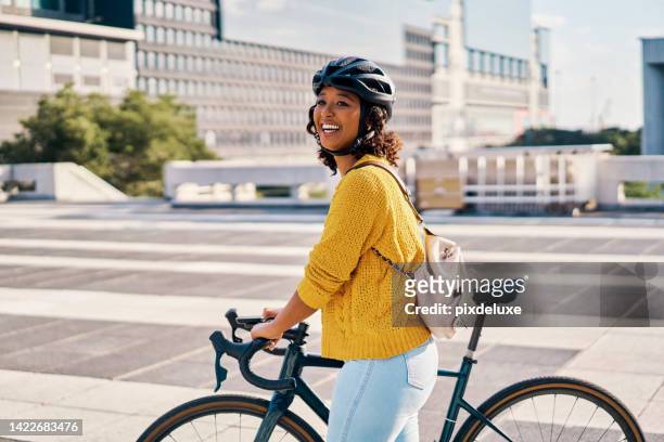 bike, cycling and green transport of a woman with a happy smile and bicycle. happiness in a city with eco friendly, sustainable and carbon neutral person transport for sustainability in a urban town - carbon cycle stockfoto's en -beelden