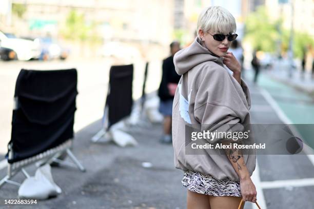 Veronica Guilty is seen wearing a Yeezy Gap Baleciaga hoodie, dress by Reformation, shoes Marine Serre and a bag by Jacquemus to NYFW at Spring...
