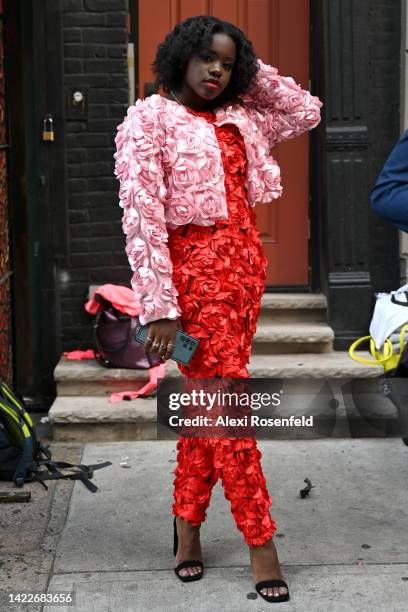 Model wearing a red flower jumpsuit and pink flower jacket, both by JBrand- Vintage is seen before the JBrand- Vintage Runway at Mishka restaurant in...