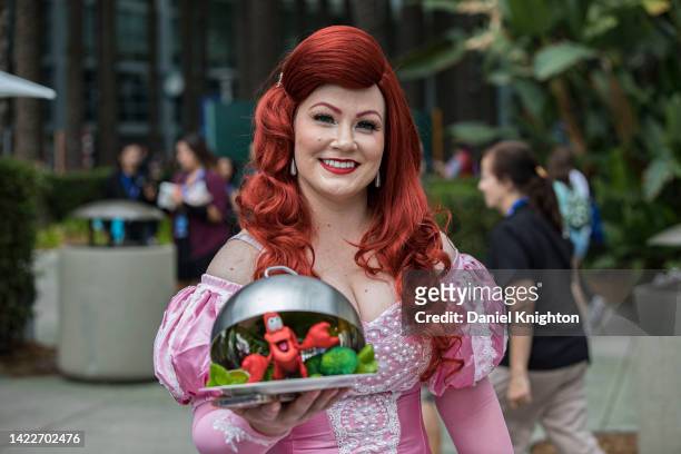 Little Mermaid cosplayer Courtney Richardson as Ariel poses for photos outside Disney's D23 Convention on September 10, 2022 in Anaheim, California.