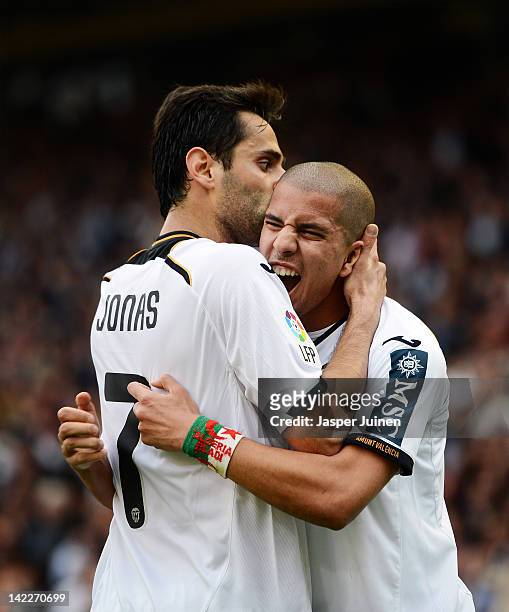 Jonas of Valencia celebrates scoring his sides opening goal with his teammate Sofiane Feghouli during the la Liga match between Valencia CF and...