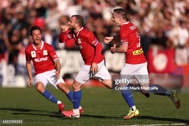 Glen Trifiro of Sydney United 58 FC celebrates with team mates after scoring a goal during the Australia Cup Semi Final match between Sydney United...