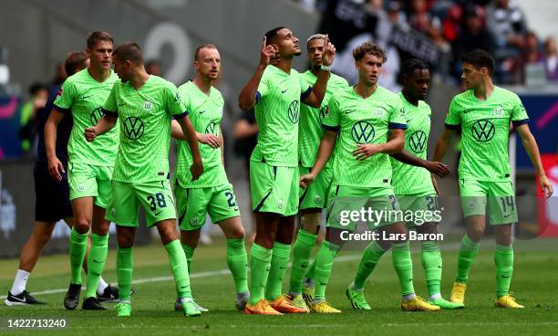 Maxence Lacroix of Wolfsburg celebrates with team mates after scoring his teams first goal during the Bundesliga match between Eintracht Frankfurt...