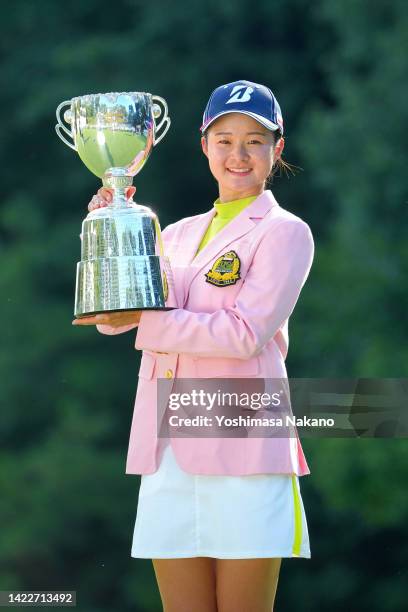 Haruka Kawasaki of Japan poses with the trophy after winning the tournament following the final round of the JLPGA Championship Konica Minolta Cup at...