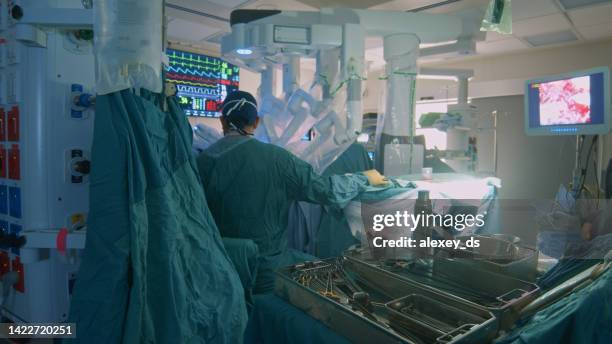 operating room nurse preparing consumables for laparoscopic surgery - surgical robot stock pictures, royalty-free photos & images