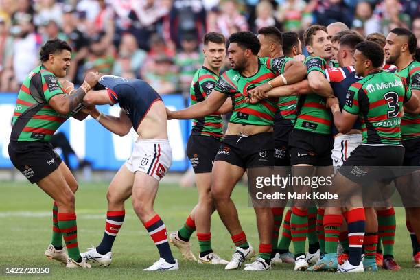 Latrell Mitchell of the Rabbitohs scuffles with Nat Butcher of the Roosters during the NRL Elimination Final match between the Sydney Roosters and...