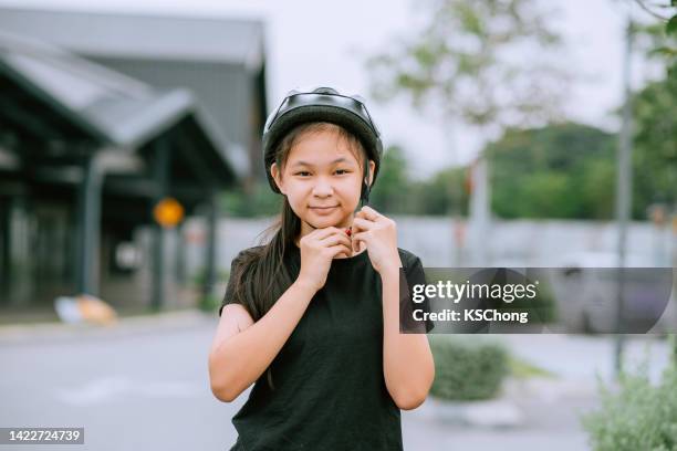 happy asian teenage girl putting cycle helmet - daily sport girls bildbanksfoton och bilder