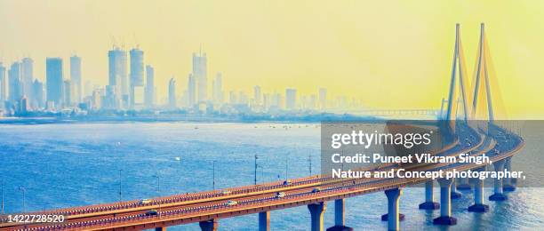 bandra worli sea link in a backdrop of modern skyline - mumbai bridge stock pictures, royalty-free photos & images