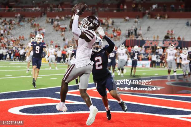 Wide receiver Caleb Ducking of the Mississippi State Bulldogs catches a touchdown despite cornerback Isaiah Rutherford of the Arizona Wildcats during...