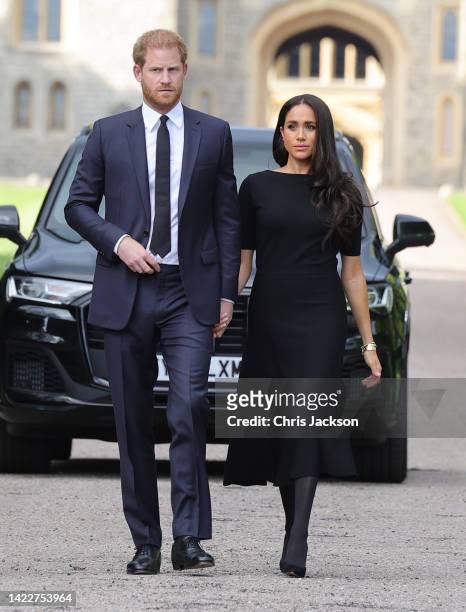 Prince Harry, Duke of Sussex, and Meghan, Duchess of Sussex arrive on the long Walk at Windsor Castle arrive to view flowers and tributes to HM Queen...