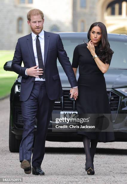 Prince Harry, Duke of Sussex, and Meghan, Duchess of Sussex arrive on the long Walk at Windsor Castle arrive to view flowers and tributes to HM Queen...