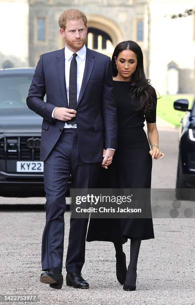 Prince Harry, Duke of Sussex, and Meghan, Duchess of Sussex arrive on the long Walk at Windsor Castle arrive to view flowers and tributes to HM Queen...