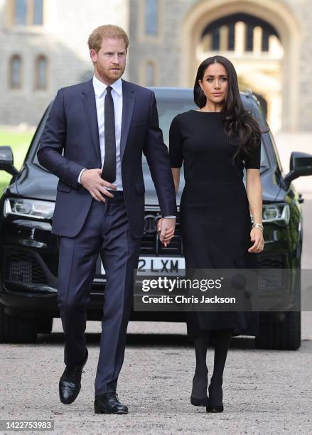 Prince Harry, Duke of Sussex, and Meghan, Duchess of Sussex arrive on the long Walk at Windsor Castle arrive to view flowers and tributes to HM Queen...