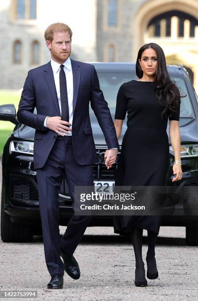 Prince Harry, Duke of Sussex, and Meghan, Duchess of Sussex arrive on the long Walk at Windsor Castle arrive to view flowers and tributes to HM Queen...