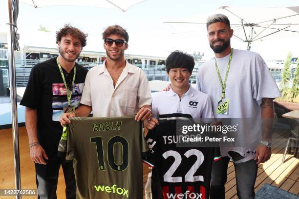 Pierre Gasly of France and Scuderia AlphaTauri and Yuki Tsunoda of Japan and Scuderia AlphaTauri pose for a photo with Olivier Giroud and Davide...