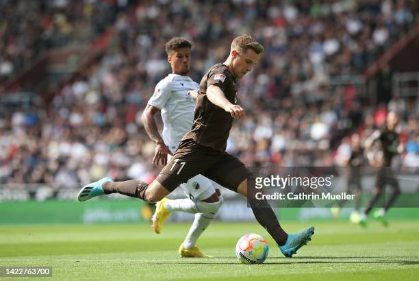 Johannes Eggestein of FC St. Pauli is challenged by Chima Okoroji of SV Sandhausen during the Second Bundesliga match between FC St. Pauli and SV...