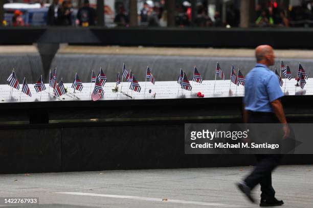 American flags are seen on the names of victims of the 9/11 terror attack during the annual 9/11 Commemoration Ceremony at the National 9/11 Memorial...