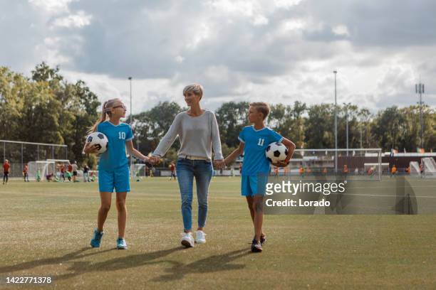 fußballmutter fußballtrainerin mit ihren kindern während einer trainingseinheit - soccer mum stock-fotos und bilder