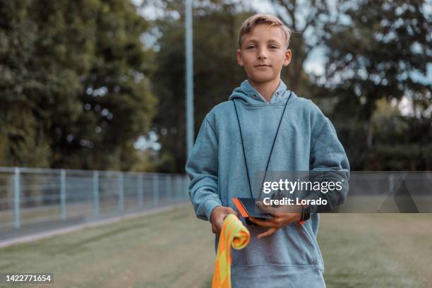 handsome young caucasian male soccer referee boy during a football match - referee stock pictures, royalty-free photos & images
