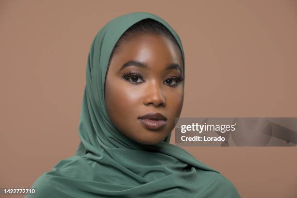 portrait of a beautiful muslim woman wearing hijab in a studio shot - beauty portrait studio shot stock pictures, royalty-free photos & images