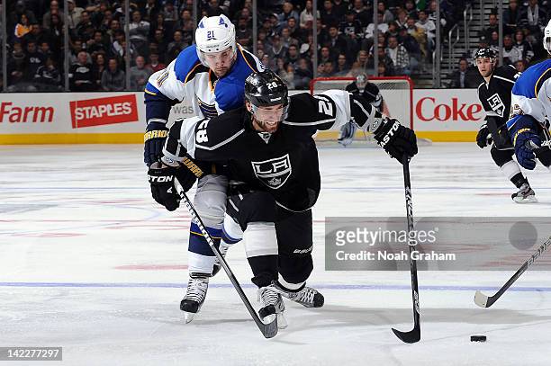 Jarret Stoll of the Los Angeles Kings reaches for the puck against Patrik Berglund of the St. Louis Blues at Staples Center on March 22, 2012 in Los...