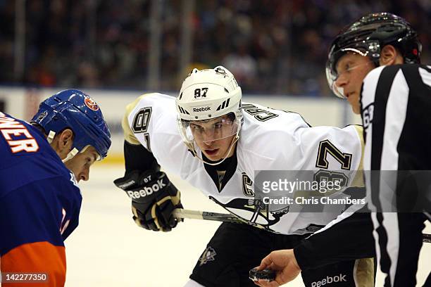 Sidney Crosby of the Pittsburgh Penguins waits for the referee to drop the box on a faceoff against Marty Reasoner of the New York Islanders at...