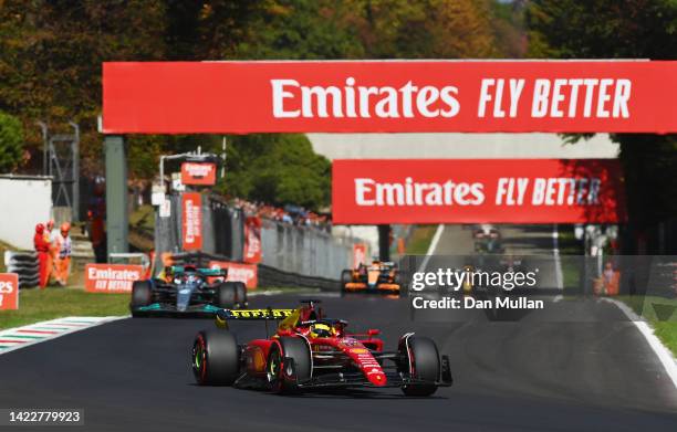 Charles Leclerc of Monaco driving the Ferrari F1-75 leads George Russell of Great Britain driving the Mercedes AMG Petronas F1 Team W13 and the rest...