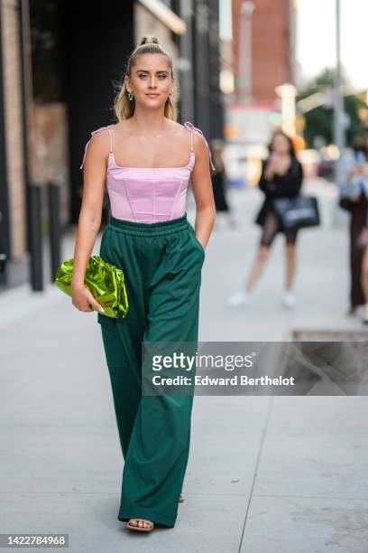 Valentina Ferragni wears neon colors and diamonds earrings, a pale pink silk square-neck / cropped corset top, a small gold Love bracelet from...