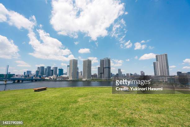 view of tokyo bayside under blue sky - toyosu stock-fotos und bilder