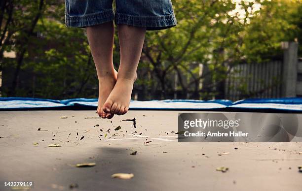 childs dirty feet  jumping on trampoline - trampolin bildbanksfoton och bilder