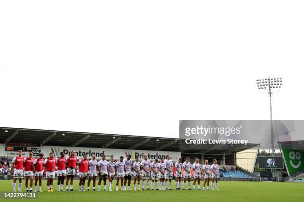 Players of Northampton Saints and spectators observe a minute silence, as they pay tribute to Her Majesty Queen Elizabeth II, who died away at...