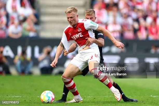 Kristian Pedersen of FC Koln battles for possession with Andras Schafer of FC Union Berlin during the Bundesliga match between 1. FC Koeln and 1. FC...