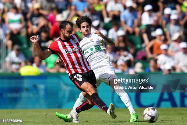 Inigo Lekue of Athletic Club battles for possession with Alex Collado of Elche CF during the LaLiga Santander match between Elche CF and Athletic...