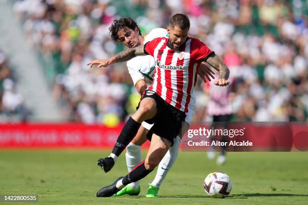 Inigo Martinez of Athletic Club battles for possession with Alex Collado of Elche CF during the LaLiga Santander match between Elche CF and Athletic...