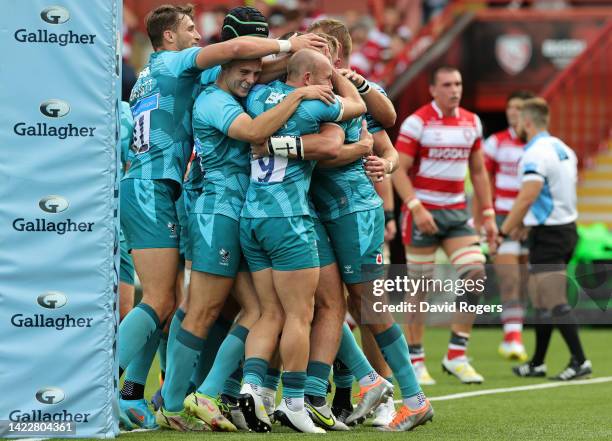 Burger Odendaal of Wasps is mobbed by team mates after scoring their third try during the Gallagher Premiership Rugby match between Gloucester Rugby...