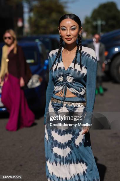 Jessica Wang seen wearing a blue and white Altuzarra long dress, white heels, beige handbag and silver earrings outside Altuzarra during New York...