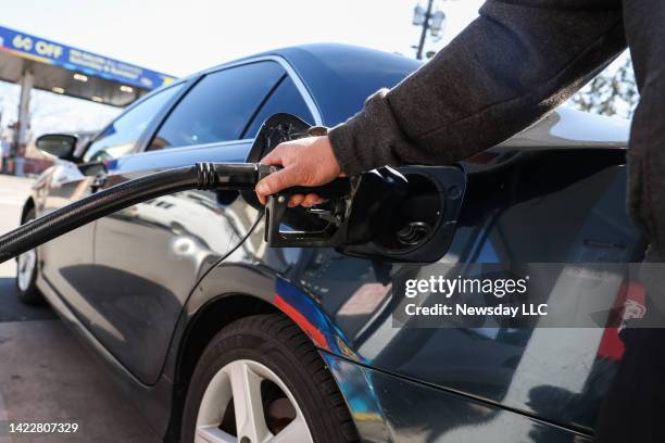 Customer fills up his vehicle gas tanks at the Sunoco gas station in Hauppauge, New York, on March 11, 2022.