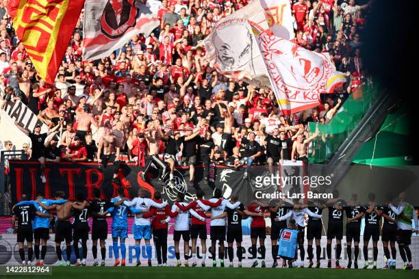 Union Berlin players celebrate with their fans following their sides victory in the Bundesliga match between 1. FC Koeln and 1. FC Union Berlin at...