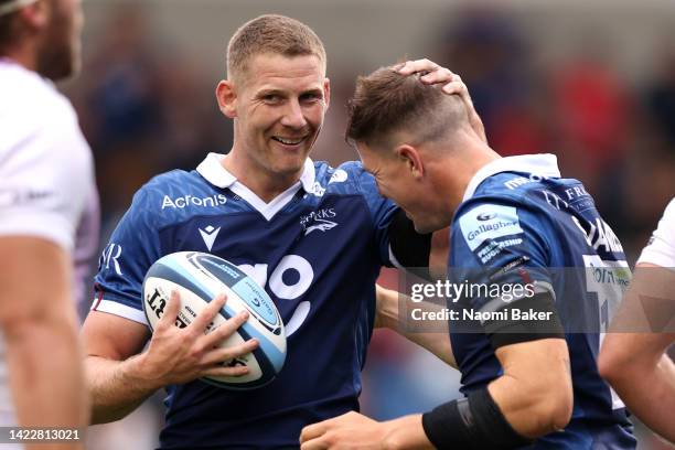 Sam James of Sale Sharks celebrates scoring their side's third try with teammate Robert du Preez during the Gallagher Premiership Rugby match between...