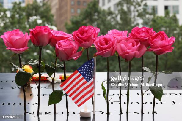 Flowers are placed on the names of victims of the 9/11 terror attack in the North Tower Memorial Pool during the annual 9/11 Commemoration Ceremony...