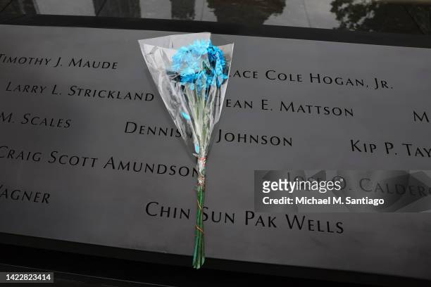 Flowers are seen resting on the names of victims of the 9/11 terror attack on the North Tower Memorial Pool during the annual 9/11 Commemoration...