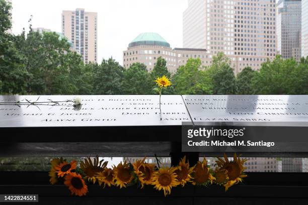 Sunflowers are seen on the names of victims of the 9/11 terror attack on the North Tower Memorial Pool during the annual 9/11 Commemoration Ceremony...
