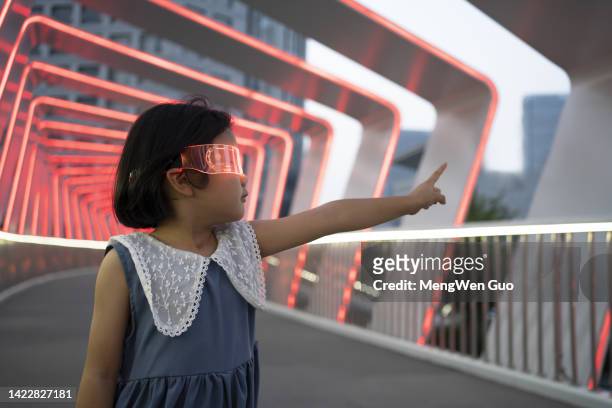 modern little girl wearing glowing glasses - cyber punk girl stock pictures, royalty-free photos & images
