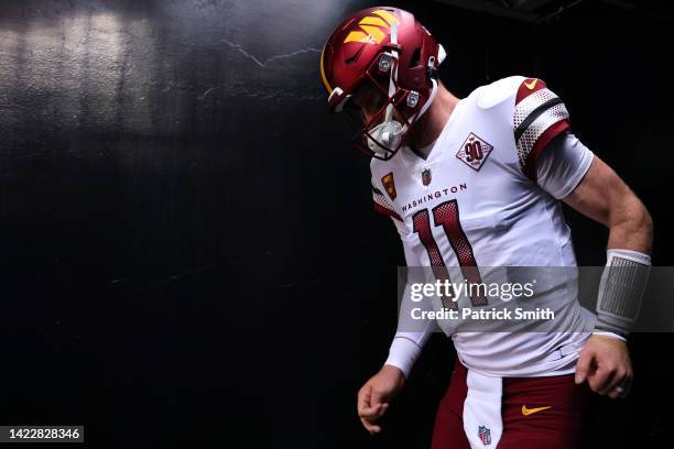 Carson Wentz of the Washington Commanders takes the field for warm ups before the game against the Jacksonville Jaguars at FedExField on September...