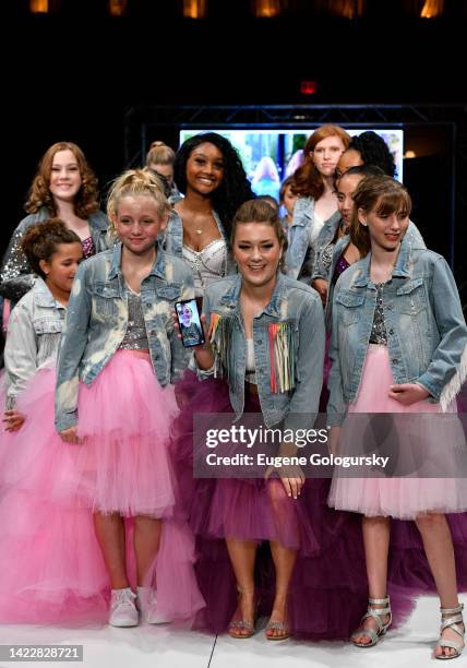 Race Austyn participates in grand finale on the runway for Sunflower By Race Austyn during Prestige NYFW at Gotham Hall on September 09, 2022 in New...