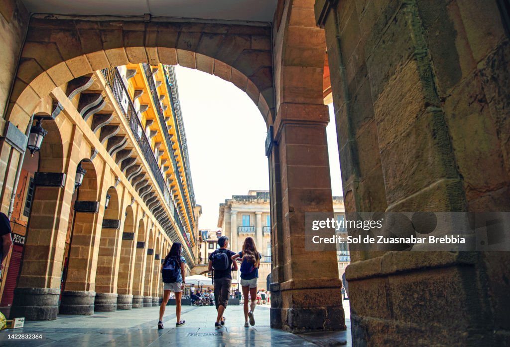 Family walking through the main square of San Sebastian.