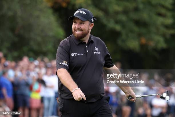 Shane Lowry of Ireland celebrates after putting on the 18th hole, putting them into the lead, during Round Three on Day Four of the BMW PGA...