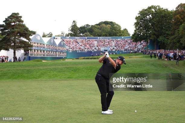 Shane Lowry of Ireland plays their second shot on the 18th hole during Round Three on Day Four of the BMW PGA Championship at Wentworth Golf Club on...