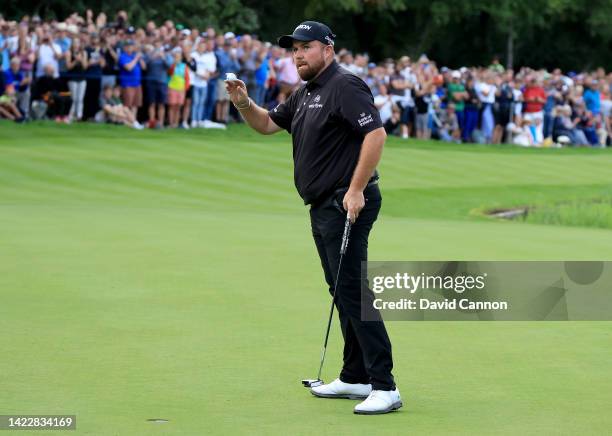 Shane Lowry of Ireland acknowledges the crowds on the 18th hole after holing out for a winning birdie during the final round on day four of the BMW...